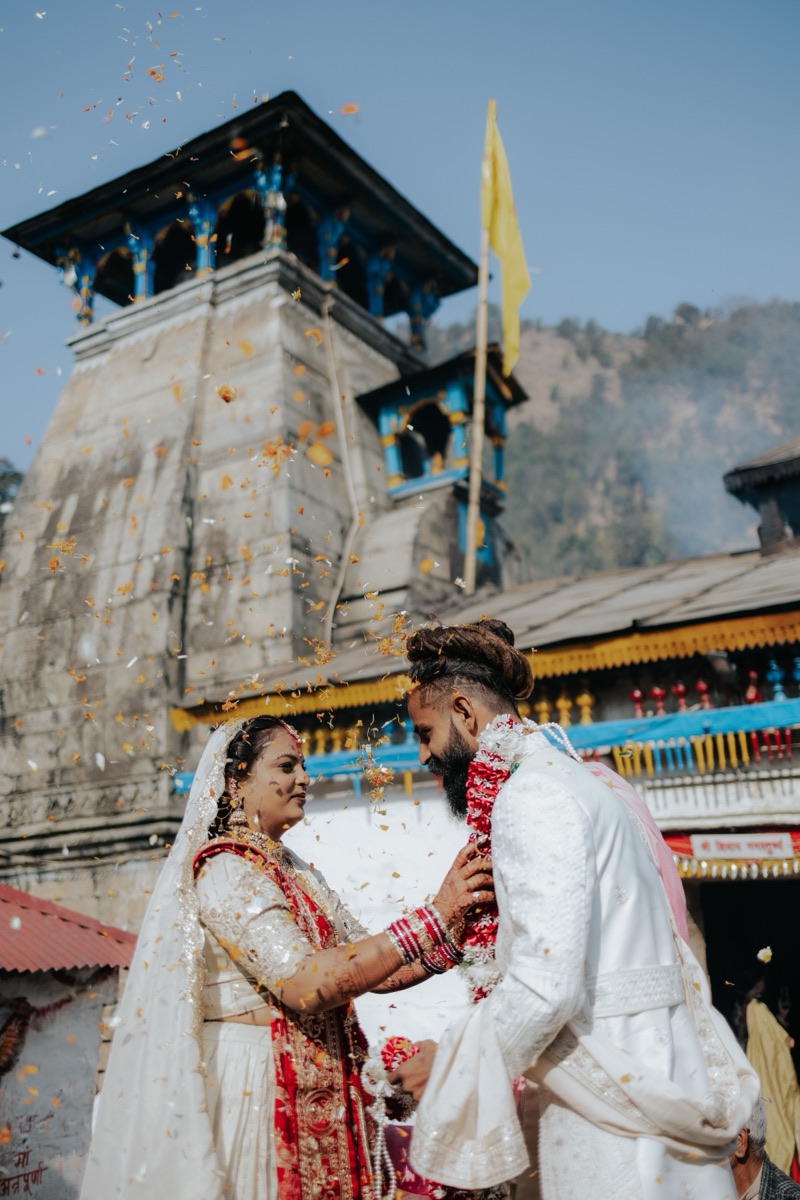A couple married at the Triyuginarayan temple near Kedarnath, petals falling